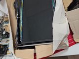 a laptop computer sitting in a box on top of a table