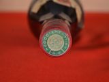 a close up of a bottle of wine on a red cloth