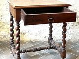 a small wooden table with a drawer on top of it