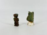 pair of small figurines of a man and a woman on a white surface