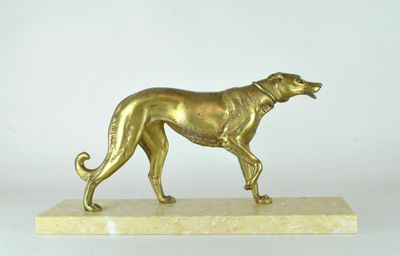 statue of a golden dog on a marble base on a white background