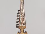 wooden musical instrument hanging from a string on a gray background