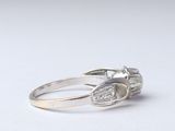 a close up of a silver ring with a diamond on it