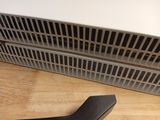 a pair of scissors sitting on the floor next to a heater