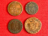 three different types of coins on a red cloth