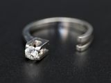 a close up of a diamond ring on a black surface