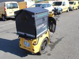 a motorcycle with a box on the back of it parked in a parking lot