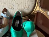 two pairs of shoes sitting on top of a box