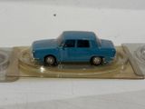 a blue toy car sitting on top of a glass plate