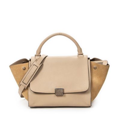 a beige handbag on a white background with a strap