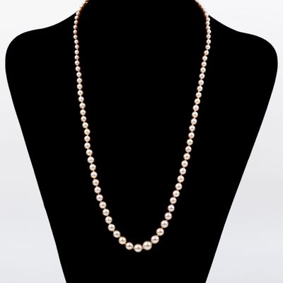 a close up of a necklace on a mannequin mannequin
