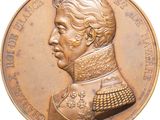 une image représentant une médaille d'or sur laquelle figure le portrait d'un homme