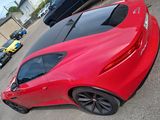 a red sports car parked in a parking lot