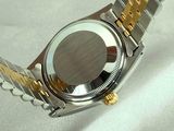 a close up of a watch on a white surface