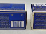 two boxes of blue and white soap sitting on a white surface