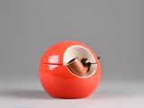 a red apple shaped container with a wooden stick inside of it