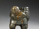 a statue of a man carrying a child on his back