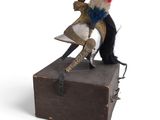 a stuffed animal that is sitting on top of a box