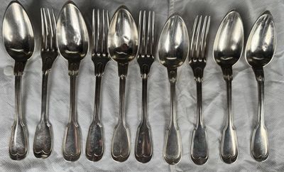 six spoons and six spoons sitting on a table