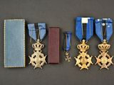 three medals and a book are sitting on a table