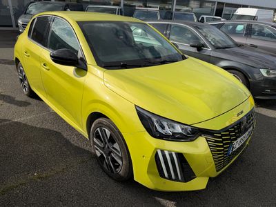 the bright yellow car is parked in the parking lot next to other cars