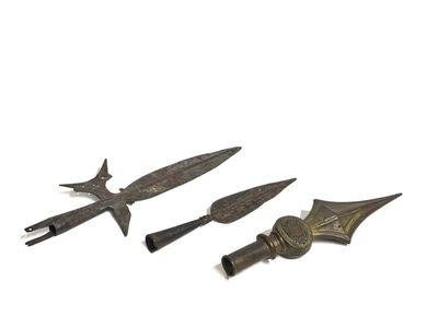 two old metal knives are sitting next to each other on a white surface