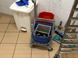 tiled floor in a bathroom with a laptop computer on a cart