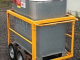 a machine that is sitting on a cart in front of a building