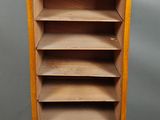an old wooden bookcase with a drawer on top of it