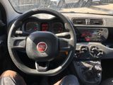 dashboard of a small car with a steering wheel and dashboard controls