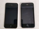 two iphones sitting next to each other on a table