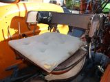 a seat in the back of a tractor with a seat cushion