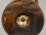 a close up of a brass object on a white surface