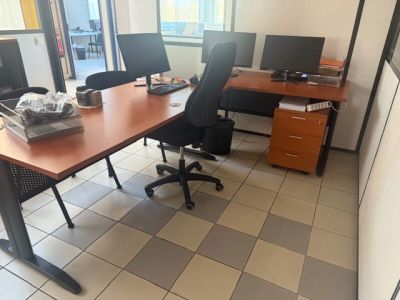 an image of an office with two desks and two monitors