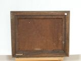 painting on a wooden easel with a white wall in the background