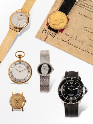 an assortment of watches and a certificate on a white surface