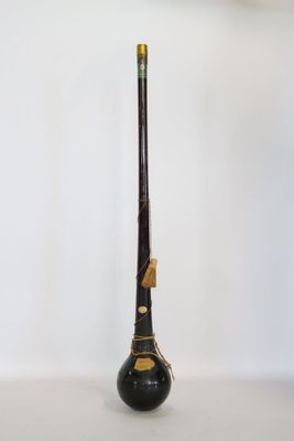 a black and gold stick on a white table