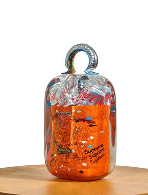 a jar of liquid sitting on top of a wooden table