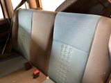 a seat in the back of a car with a remote control