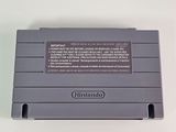 an old nintendo game console sitting on top of a white table