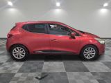 a red car parked in a garage with a checkered floor