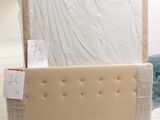 a box with a mattress on top of it in the middle of a room