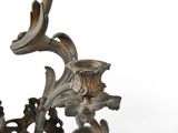 a metal candle holder that has a flower design on it