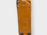 brown leather luggage bag with wheels on a white surface