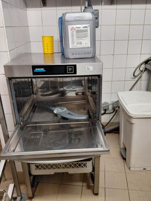 a small oven in a small kitchen with a lot of dishes in it