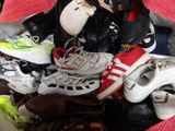 many pairs of shoes sitting in a basket on the floor