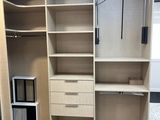 an image of a walk - in closet with shelves and drawers