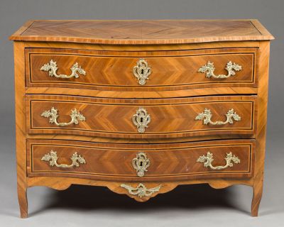 an antique chest of drawers with a wooden top and brass handles