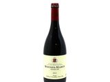 a bottle of wine sitting on top of a white table