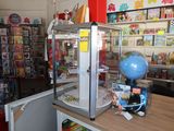 a display of toys in a toy store with a globe on top of it